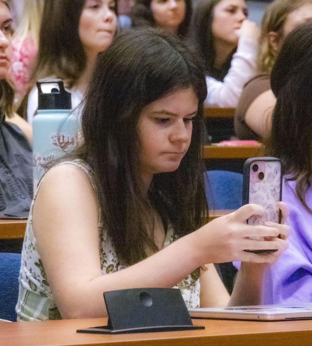 A student films the panel at the PRSSA Kent and Kent AAF Icons and Influencers event, Sept. 18, 2024.