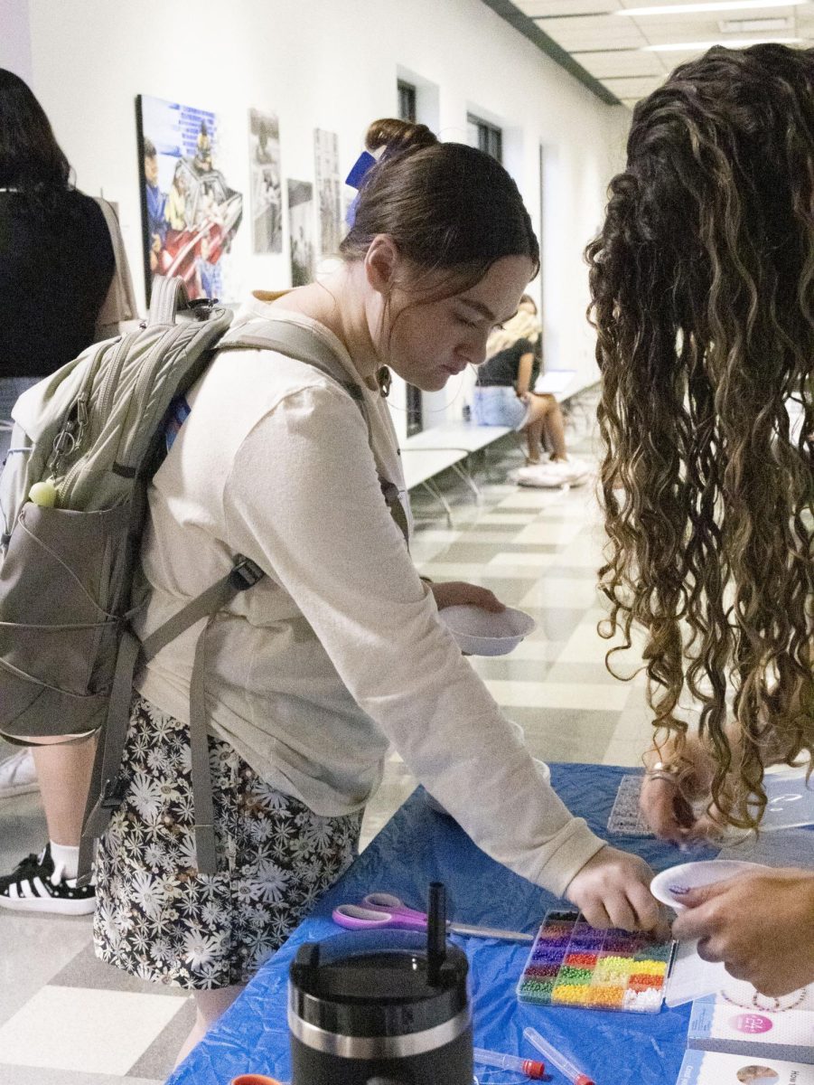 Sept. 18, 2024, a student collects beads for a friendship bracelet after the PRSSA Kent and Kent AAF Icons and Influencers event.