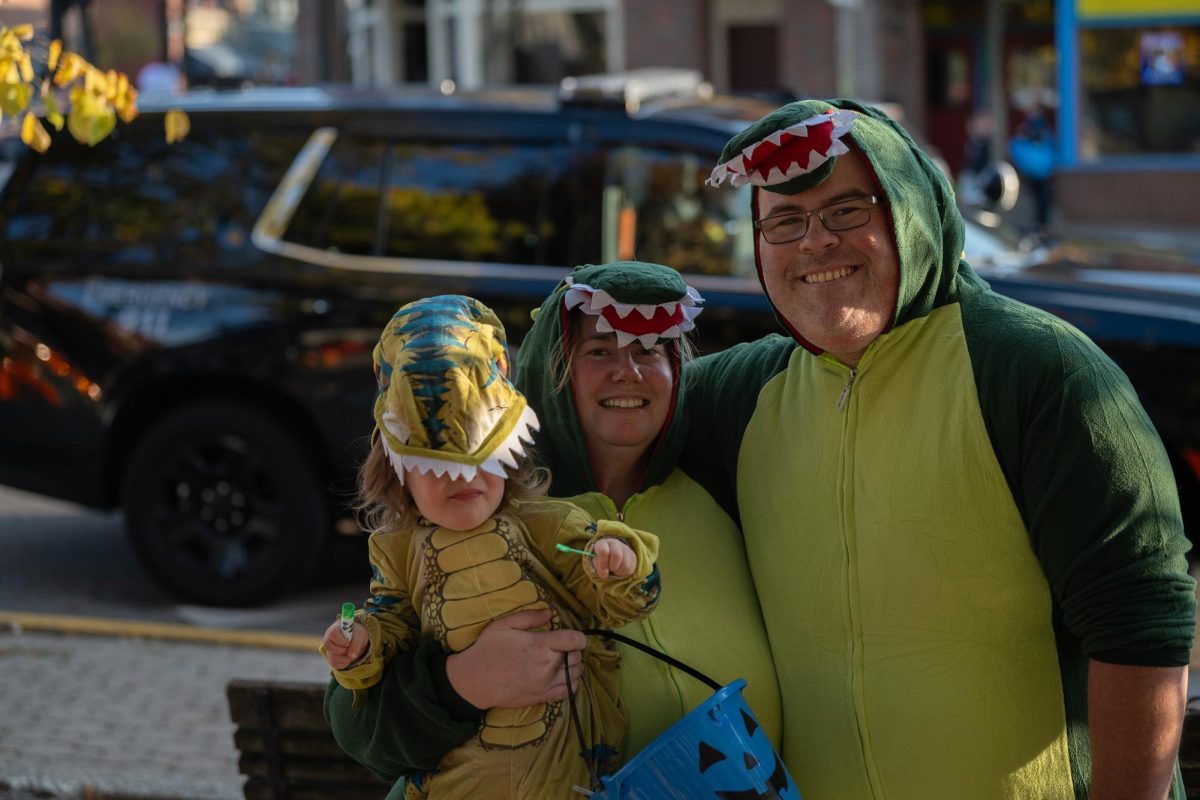 Charle,  Mike and Heather dress in matching dinosaur costumes for the Halloween Party on Oct. 25,2024. 