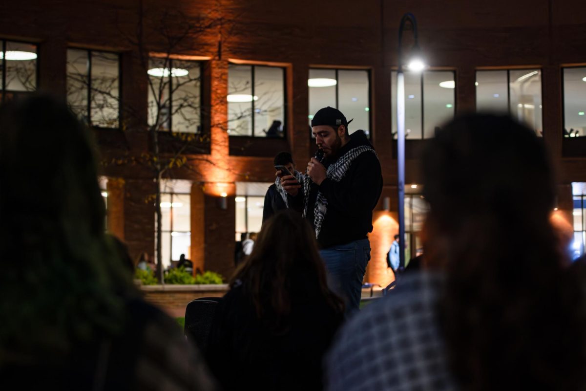 Students for Justice in Palestine event organizer Ahmad Jijakli reads off names of names of Gazan citizens who've been killed during the conflict in the middle east at the candlelight vigil, Thursday, Oct. 11, 2024. 