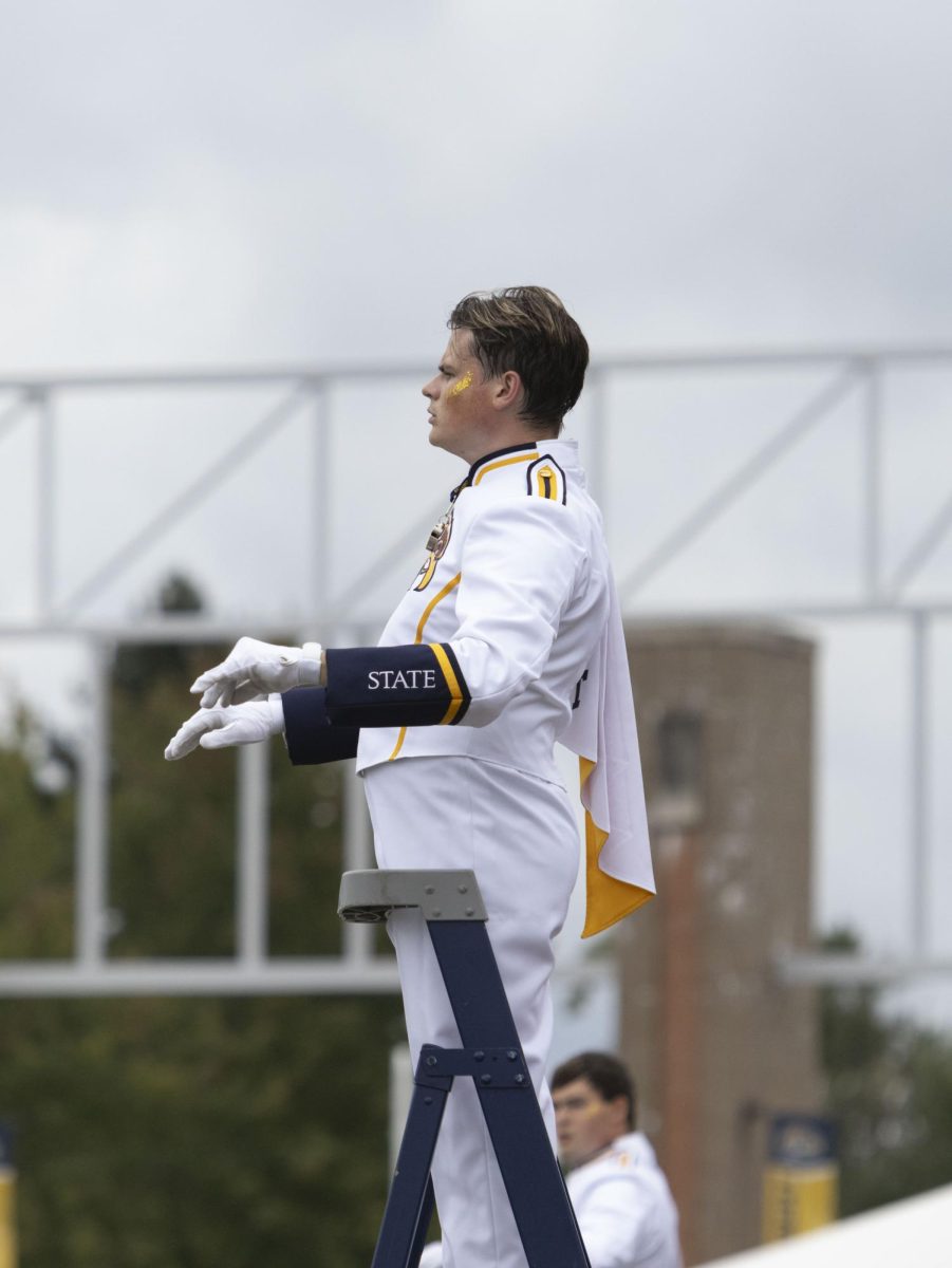 Marching Golden Flashes drum major conducts the marching band’s pregame show at the Homecoming football game against Eastern Michigan, Sept. 28, 2024.