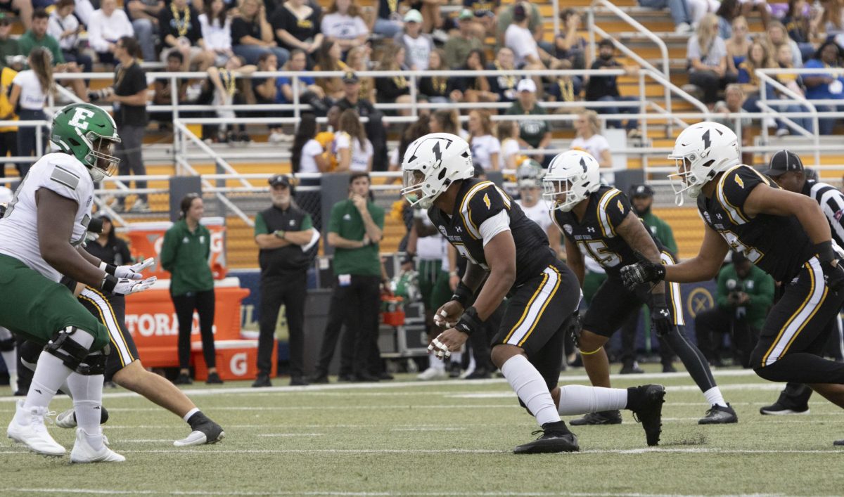 Graduate linebacker Matt Harmon (7), junior quarterback Devin Kargman (15) and freshman linebacker Jayden Studio (32) charges at Eastern Michigan junior defensive back Dramarian McNulty (7) at the Homecoming football game against Eastern Michigan, Sept. 28, 2024.