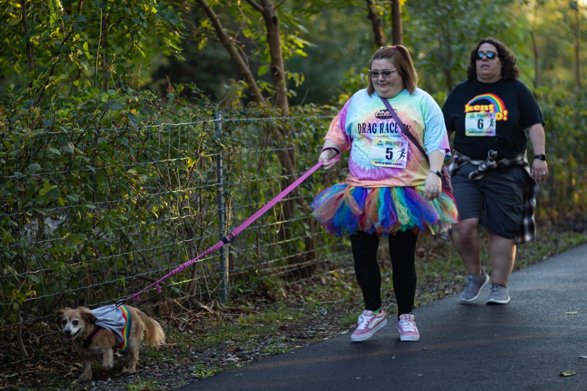 Drag Race participant walks their dog during the Drag Race 5k on Oct. 11, 2024.