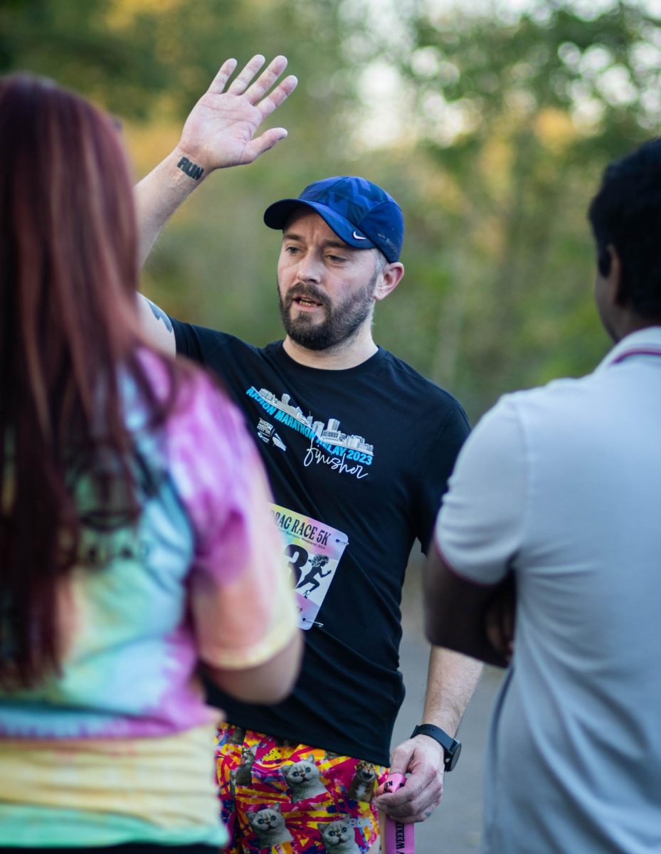 First place finisher for the Drag 5k high fives someone after finishing on Oct. 11, 2024.