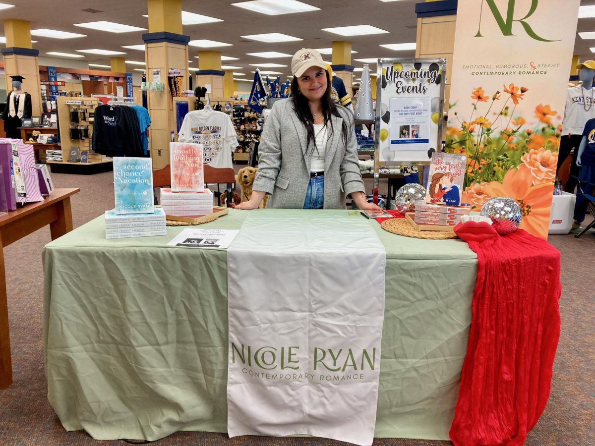 Author Nicole Ryan stands at her table to sign books at the University Bookstore Sept. 28, 2024.