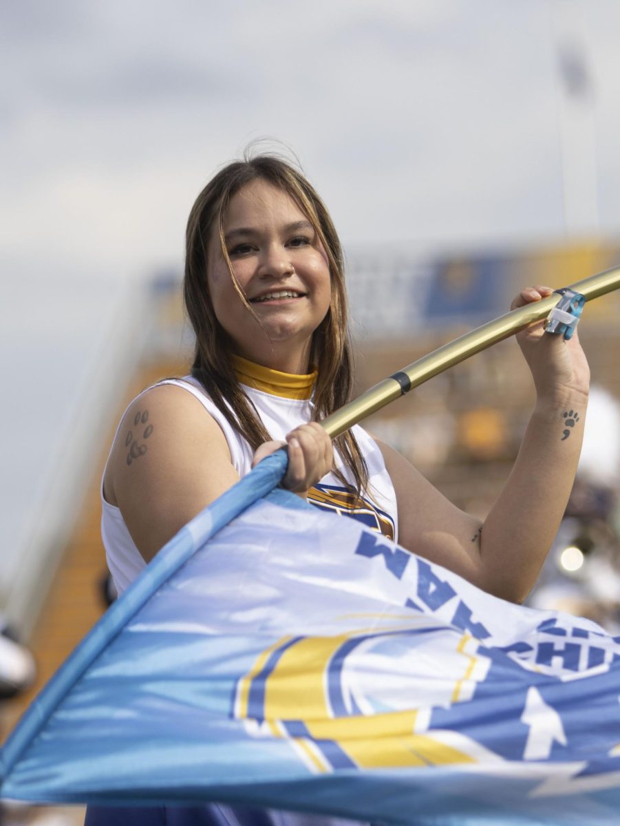 A member of the Marching Golden Flashes Color Guard performs during the halftime show at the football game against Ball State University, Oct. 12, 2024.