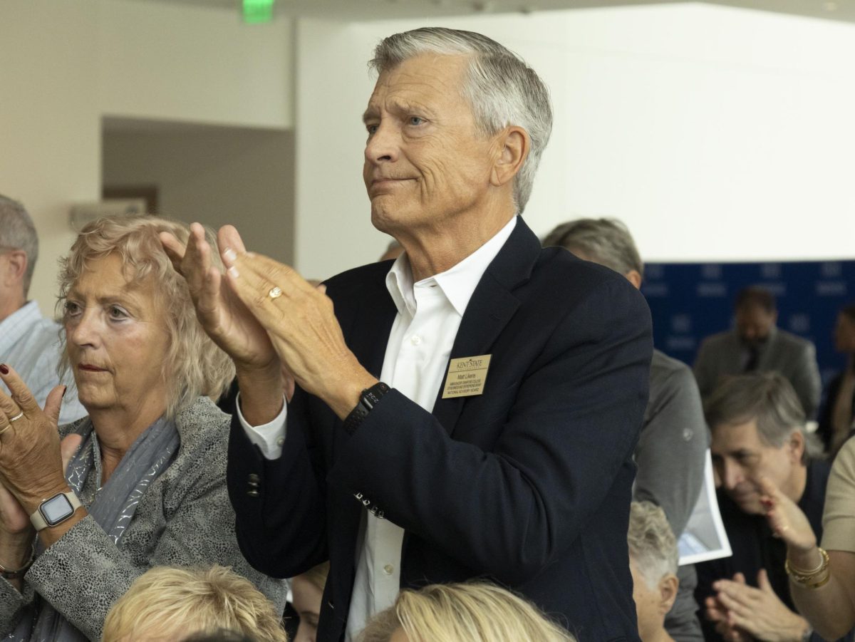 Matt Likens, member of the Kent State Ambassador Crawford College of Business and Entrepreneurship National Advisory Board, applauds at President Todd Diacon’s speech at the Sept. 27, 2024 Crawford Hall grand opening.