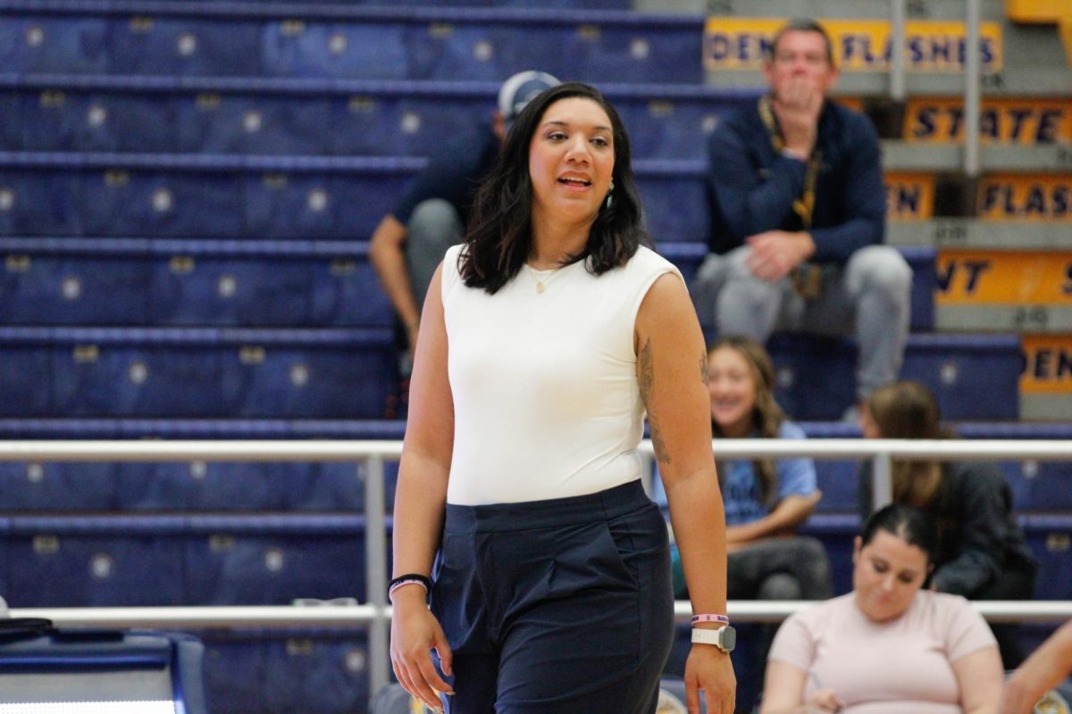 Kent State University volleyball coach Haley Eckerman speaks to players on the floor from the sideline during their match up against Ball State University on Oct. 19, 2024.