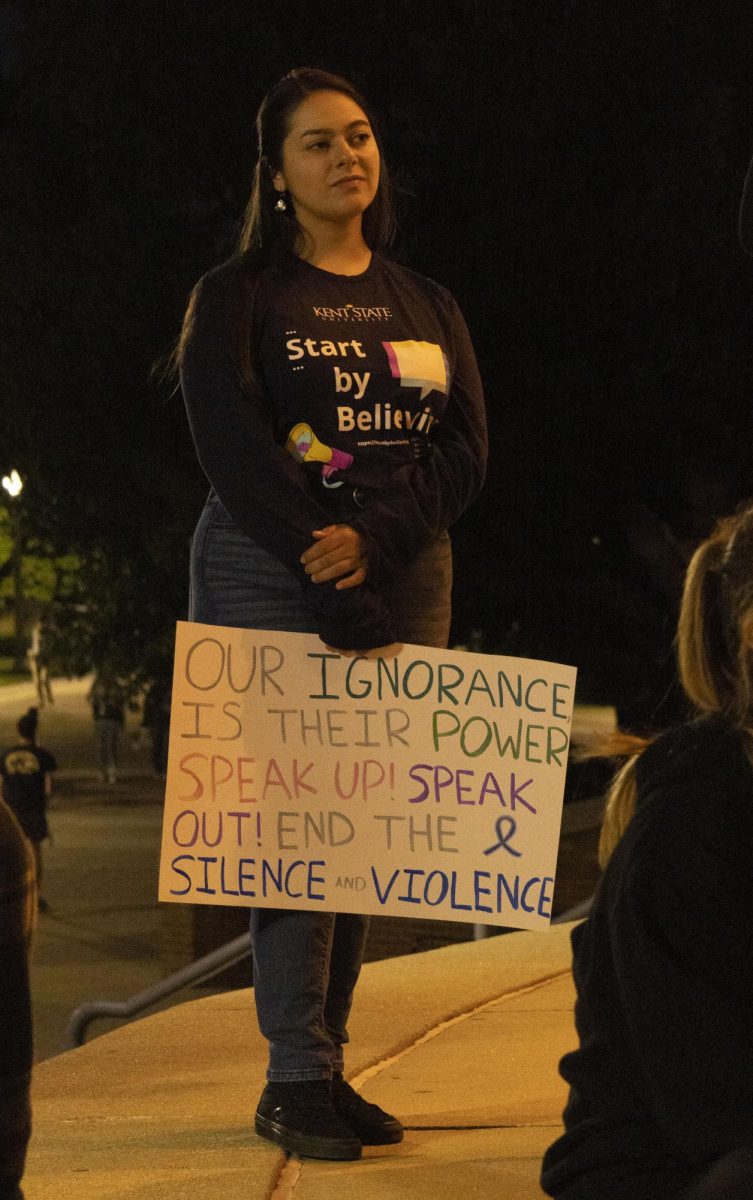 A student listens to speakers at the Oct. 3, 2024, Take Back the Night March.