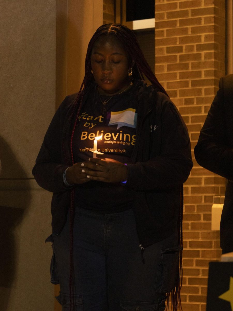 A student participates in a moment of silence in honor of victims of sexual and domestic violence at the Take Back the Night march, Oct. 8, 2024.