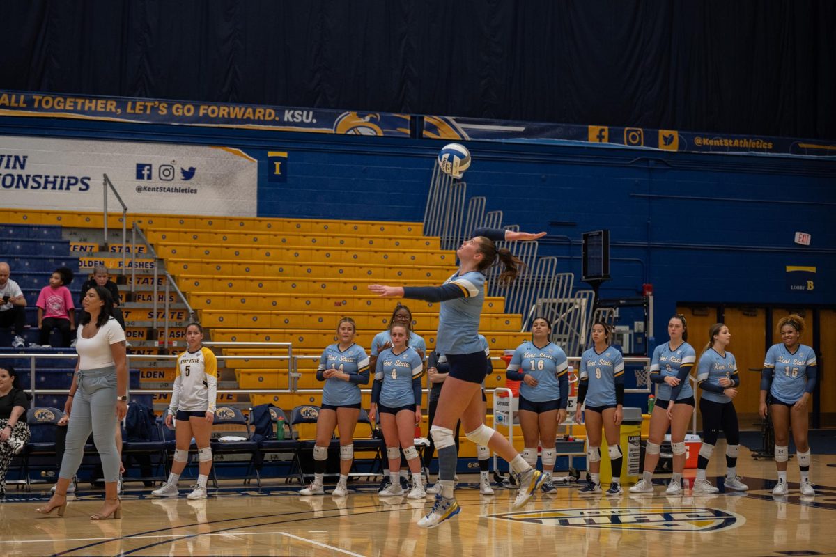 Junior Kendall White serves the ball at the Volley Ball Game against Akron's team. 