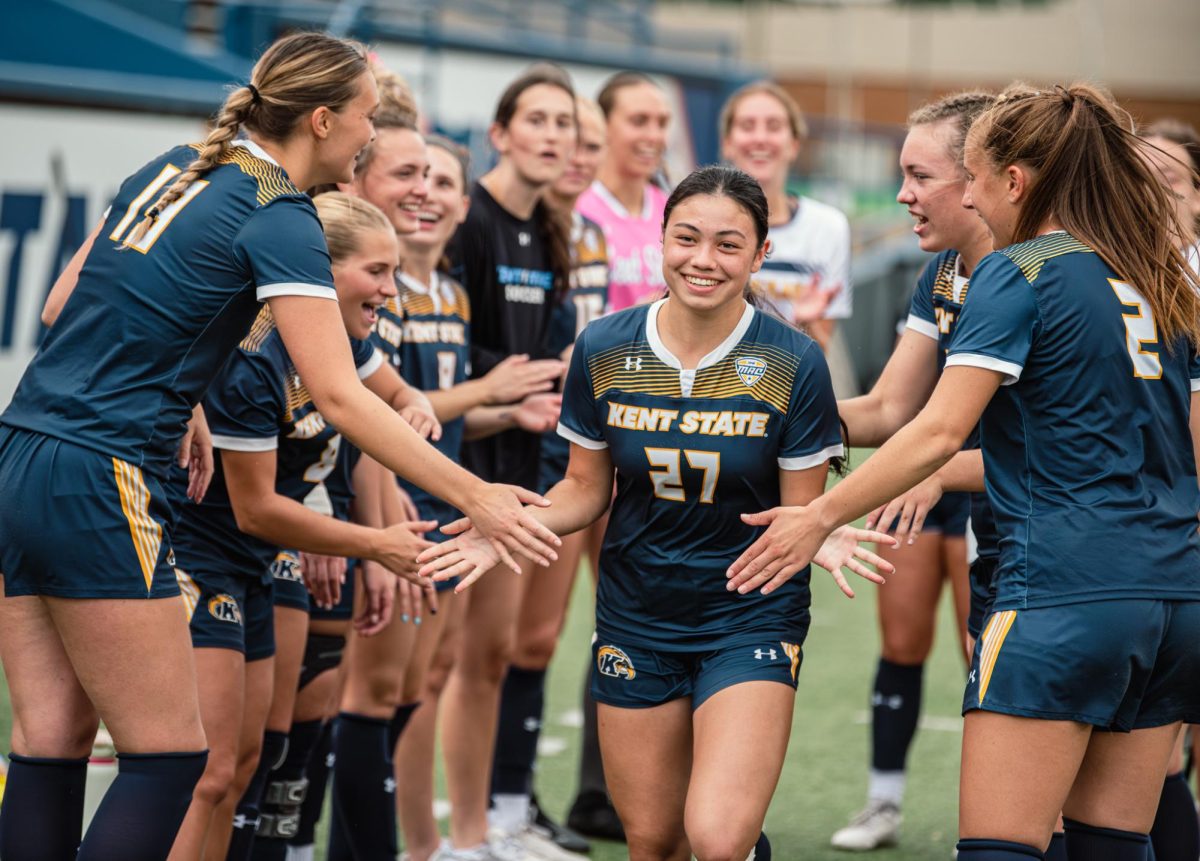 Katie Henahan, Kent State freshman midfielder, is cheered on by her team as they introduce the starting lineup before the start of the game against Bowling Green, Oct. 31, 2024.