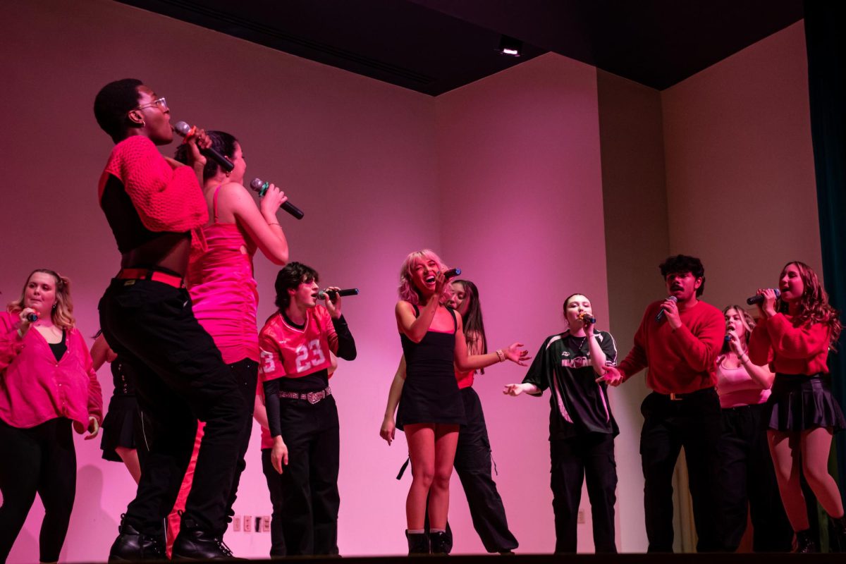 Fourth year music education major Melaina Uhrig, center, sings alongside other Vocal Intensity members at the KIVA during their Bring the Beat In concert, Friday, Nov. 22, 2024.