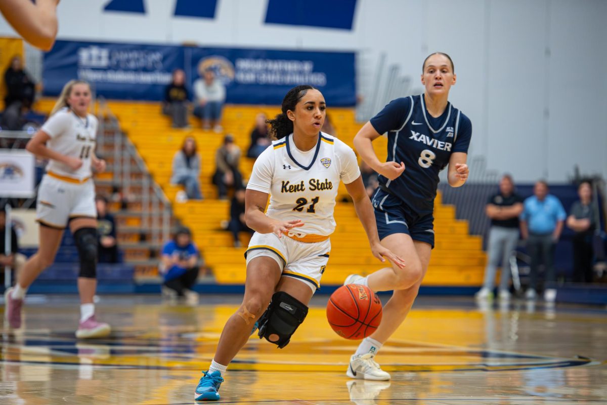 Kent junior Dionna Gray, 21, runs the ball up-court during the first quarter of the game against Xavier, Saturday, Nov. 23, 2024.