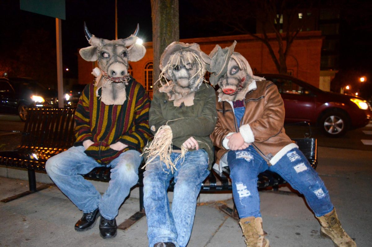 Kent State students sit in silence with their costumes at the end of the line to get into Barfly in Kent, Ohio, on November 2, 2024. 