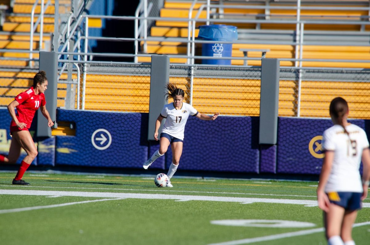 Under pressure, Kent State’s Kelsey Salopek makes a pass to Allison Collins during the game against Miami University on November 3, 2024.  