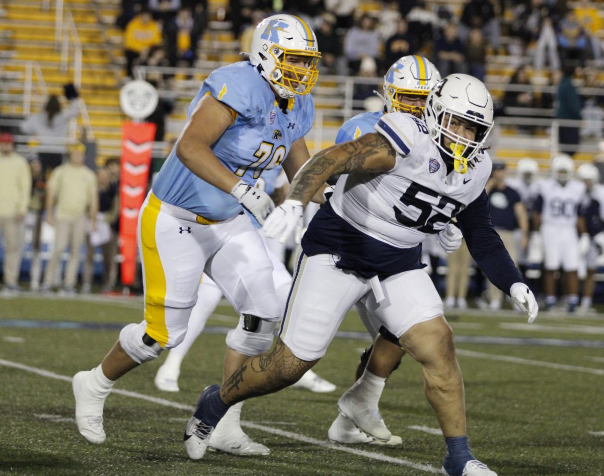 Kent State University linemen get close to tackling a Akron University lineman in their rival match on November 19,2024.