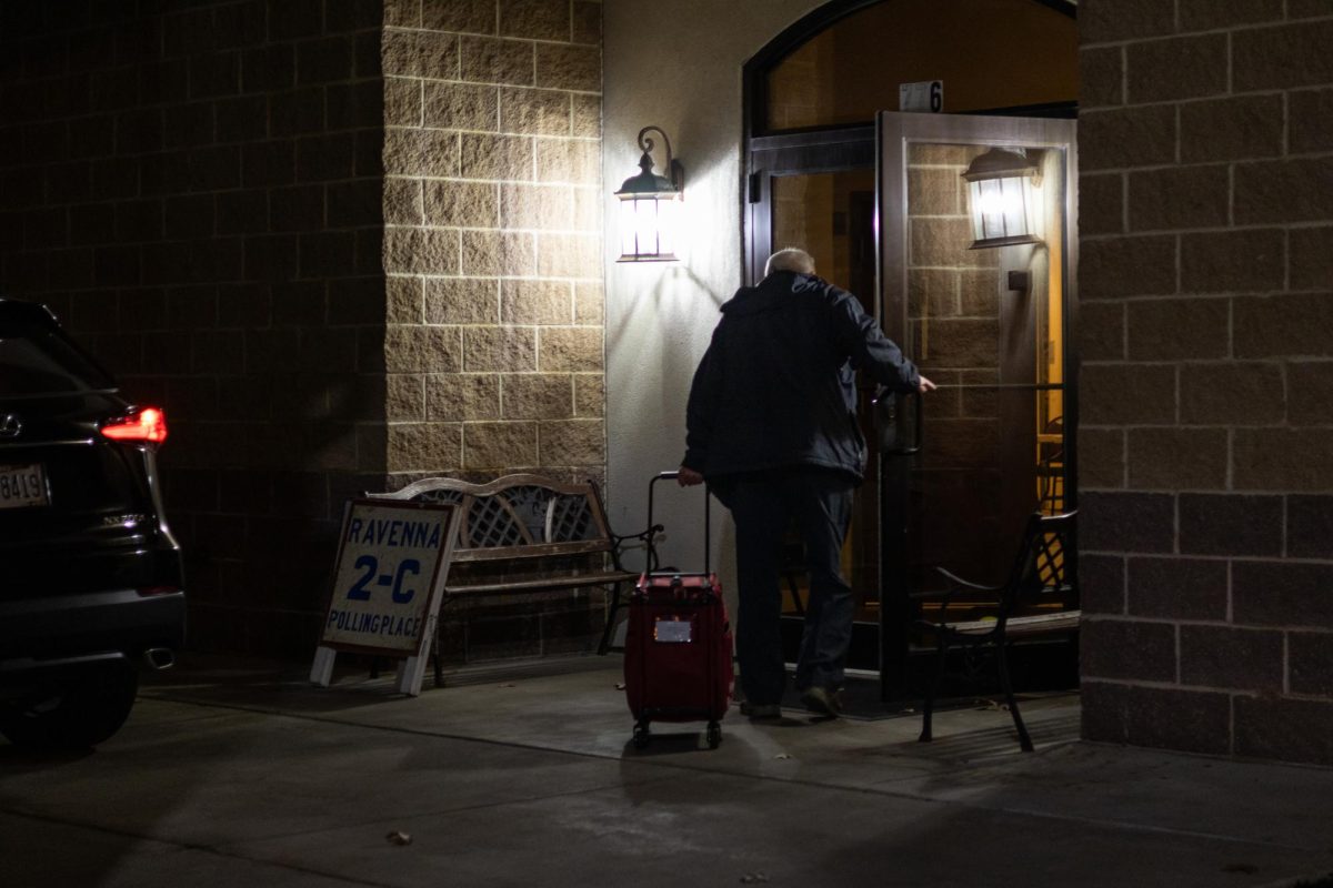 John Griffin, a polling worker, brings in a bag of supplies to the Ravenna Elk Lodge, a polling location, on Nov. 5th, 2024.