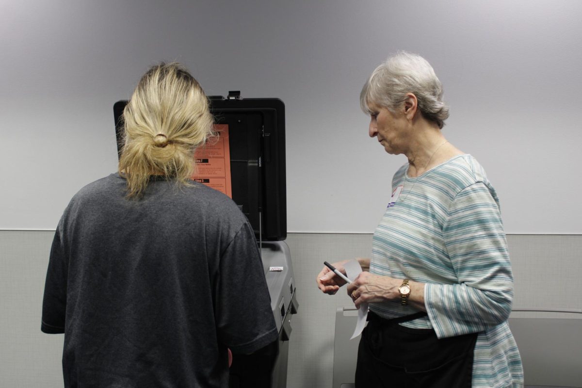 Freshman Mary Parisi put her ballot into the machine to count her vote during the presidential election at the Kent State University's Rec and Wellness Center on November 5, 2024. 