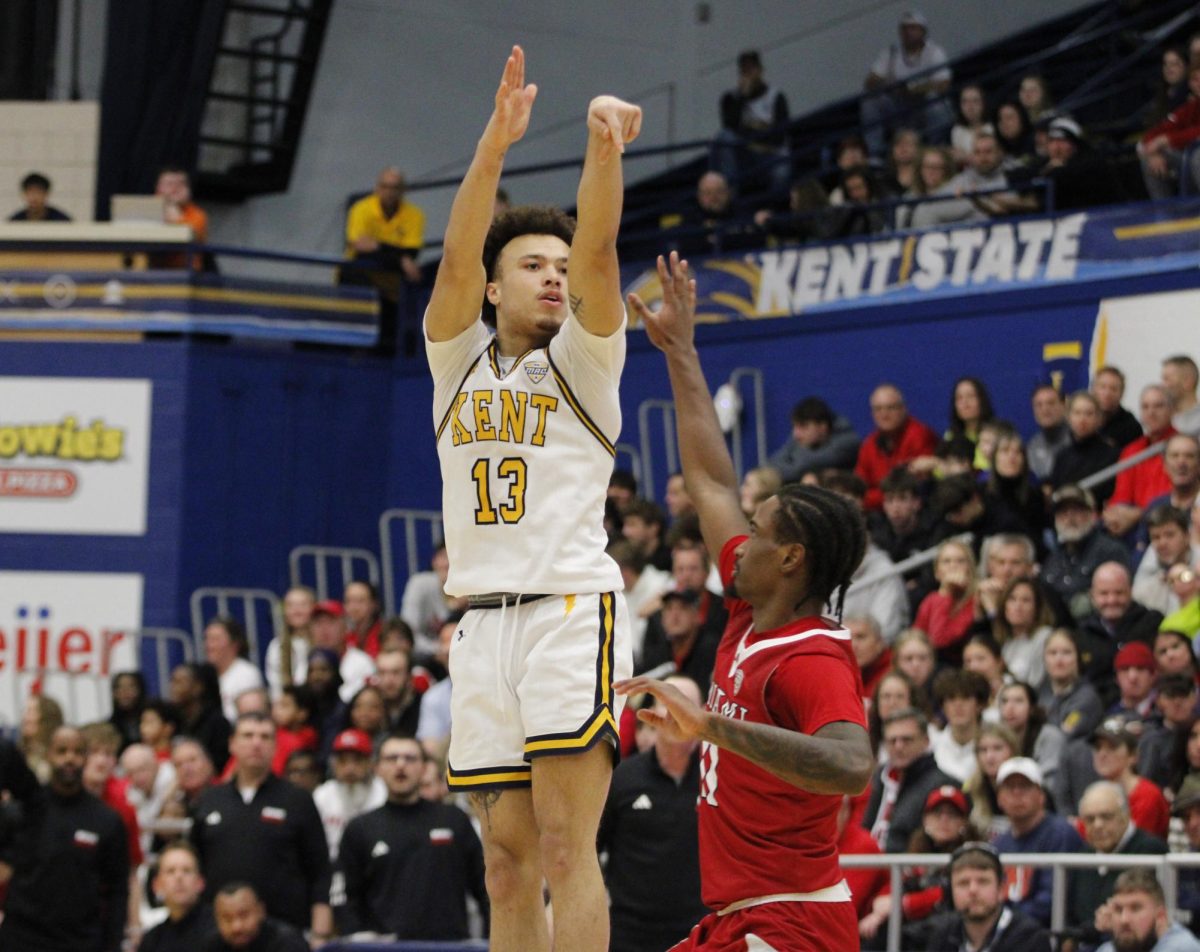 Kent State University senior guard Jalen Sullinger, 13, shoots a three-pointer while Miami OH University sophomore guard Mekhi Cooper attempts to block him in their match on Jan. 18, 2025.  