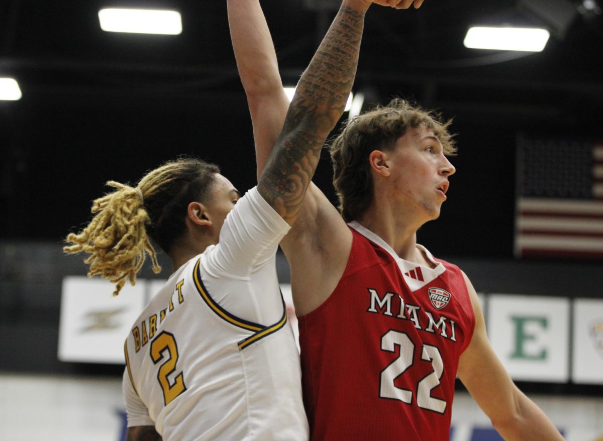 Kent State University senior guard, 2, Marquis Barnett shooting a three pointer while Miami OH University freshman wing Brant Byers, 22, blocks the shot in their game on Jan 18,2025. 