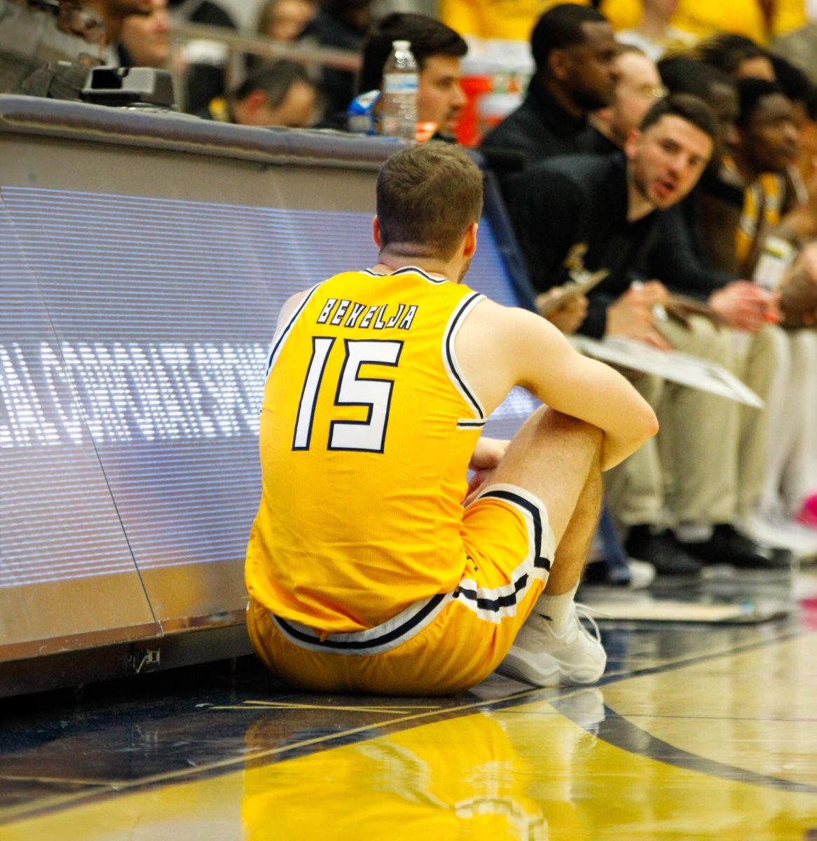 Kent State University graduate student guard Mike Bekelja sits in front of the panel's to go into the game in their match against Akron University on Jan. 31, 2025. 