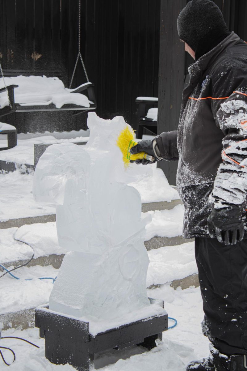 Elegance Ice Creations worker Ken is finishing up his squirrel ice sculpture for the Snow Day event in downtown Kent on Jan. 25,2025. 