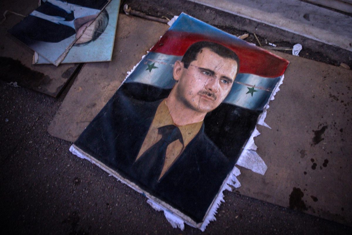 A cousin of the toppled Syrian leader Bashar al-Assad, shown on a ripped poster on December 17, who was involved in muffling the protests that started the 2011 uprising, has been detained inside Syria.