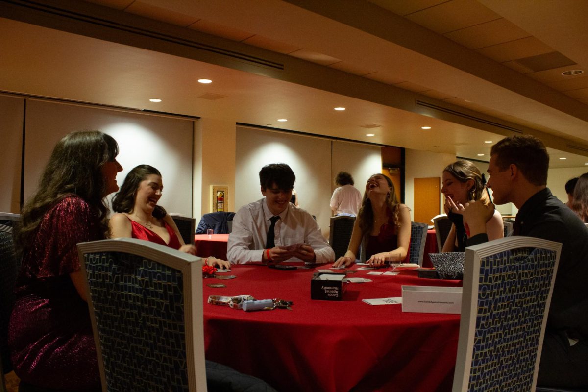 Students play a round of Cards Against Humanity at FAB's Red Dress Gala on Feb. 8th, 2025.