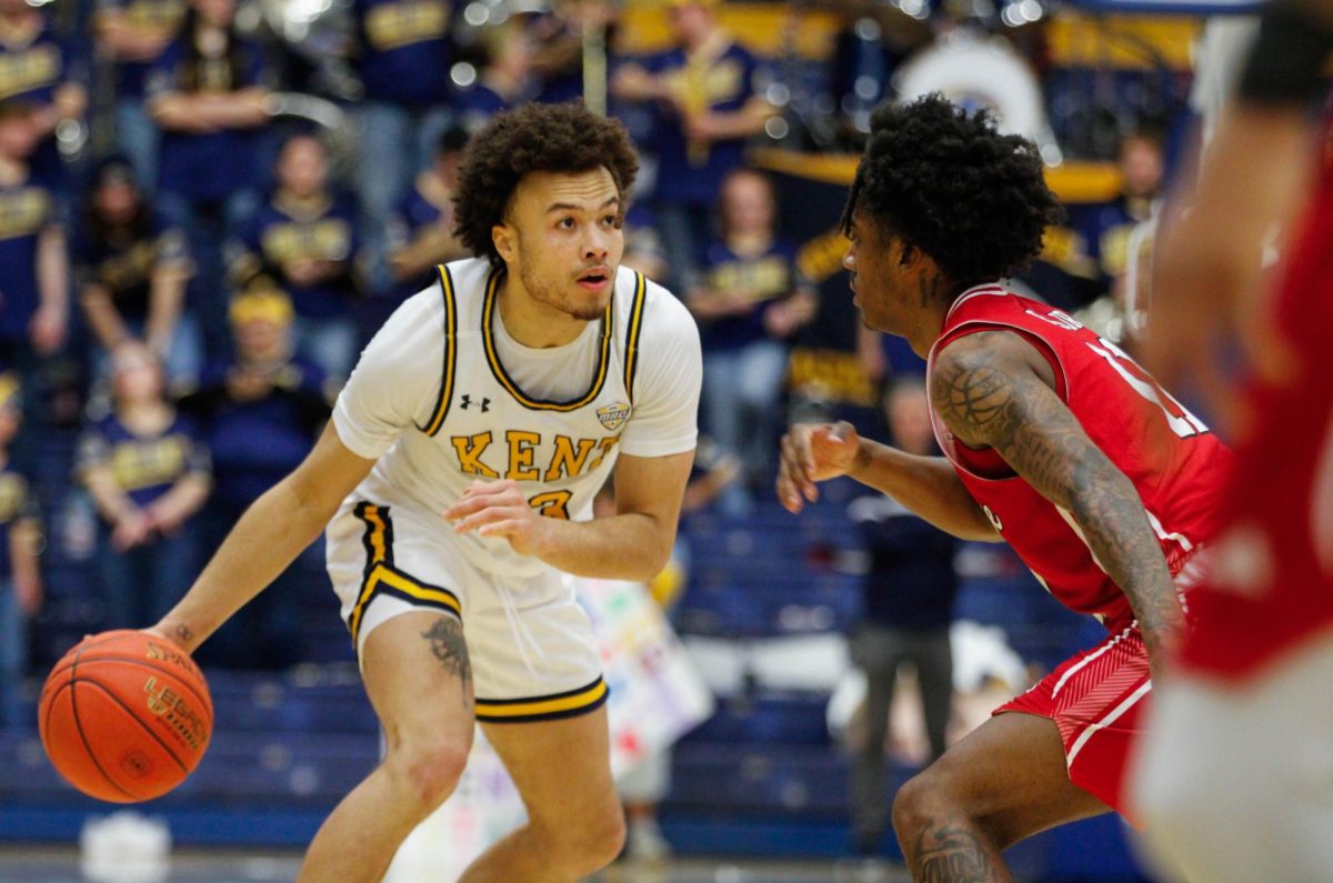 Kent senior Jalen Sullinger, 13, dribbles the ball down the court as Arkansas redshirt sophomore Terrance Ford Jr. tries to block him in the second half of their game on Saturday, Feb. 8, 2025. 