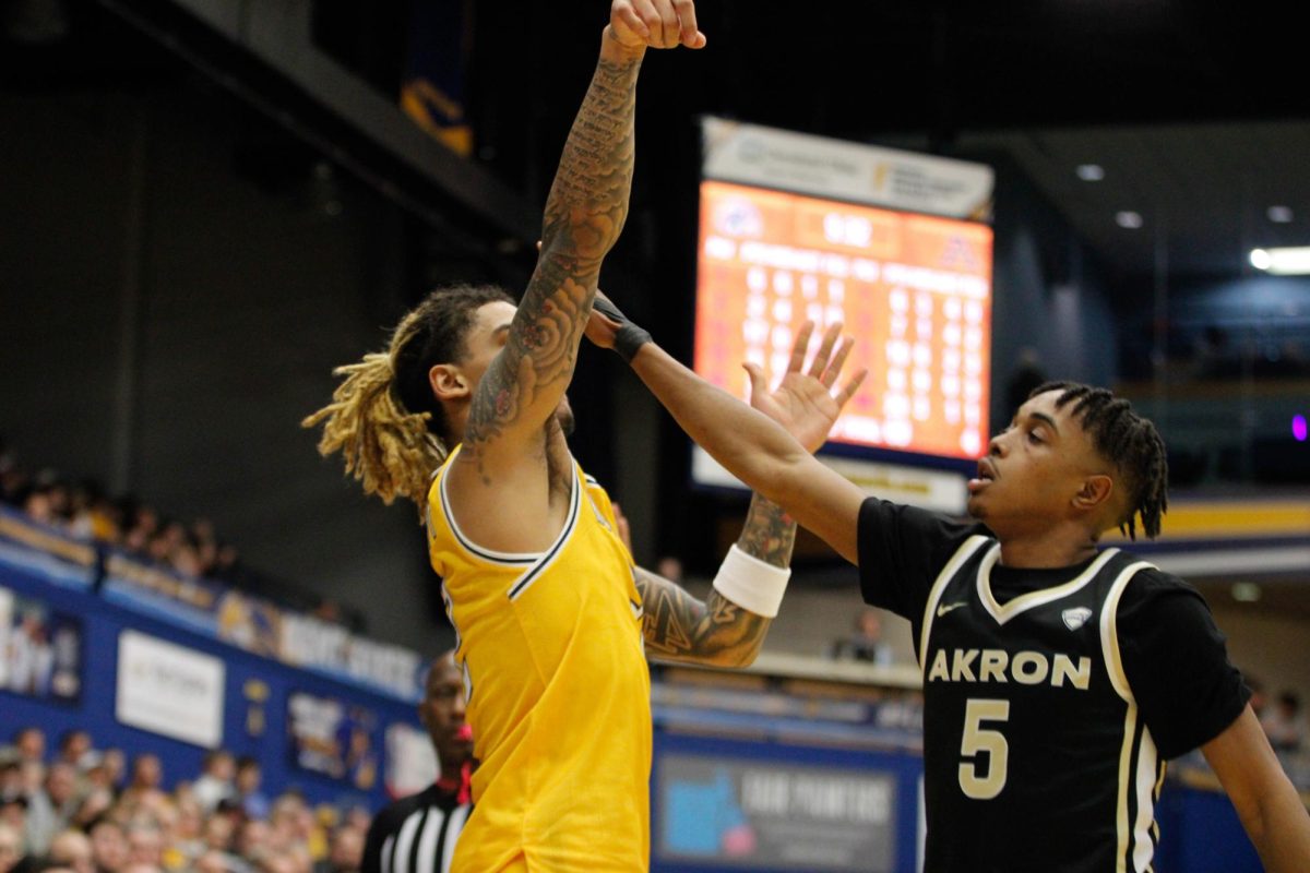 Kent State University senior guard Marquis Barnett, 2, shoots a 3-pointer as University of Akron junior guard Tavari Johnson, 5, tries to block the shot during their game on Jan. 31, 2025. 