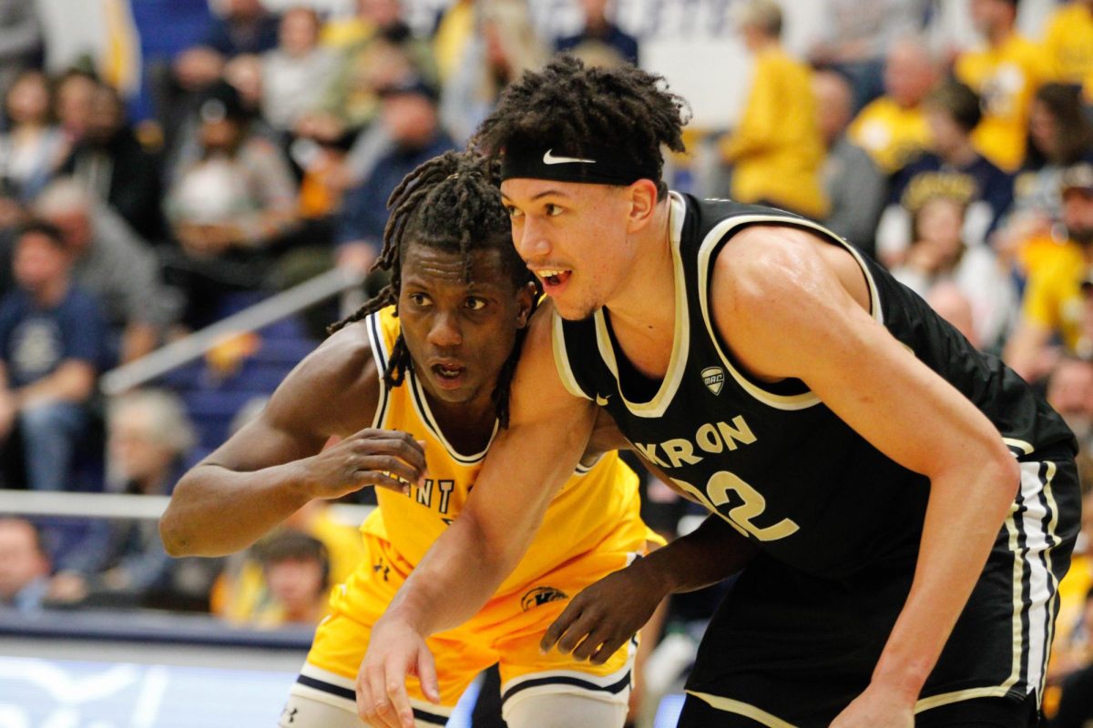 Kent State University sophomore guard Jamal Sumlin, 4, gets ready to block Akron University senior forward James Okonkwo, 32, in their match on Jan. 31, 2025. 