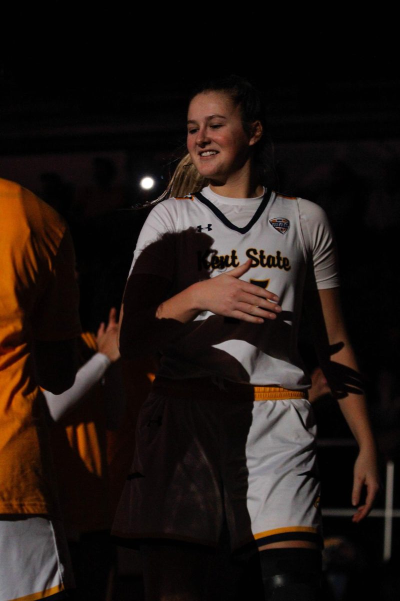 Kent State University senior forward Bridget Dunn going up to do a special handshake with her teammate as she is being introduced before their game against Akron University on Feb. 1, 2025. 