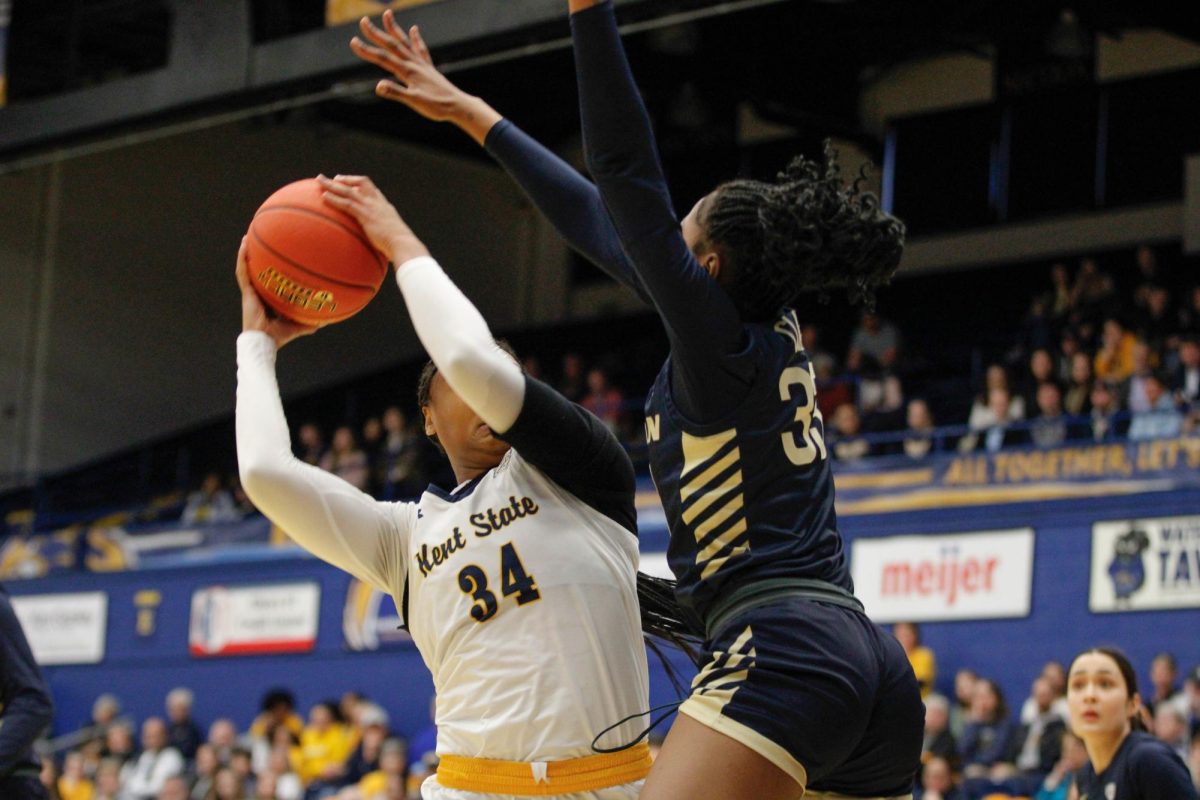 Kent State University sophomore forward Janae Tyler, 34, goes up for the layup as University of Akron freshman forward Ni'Rah Clark, 33, tries to block the layup in their match on Feb. 1, 2025. 