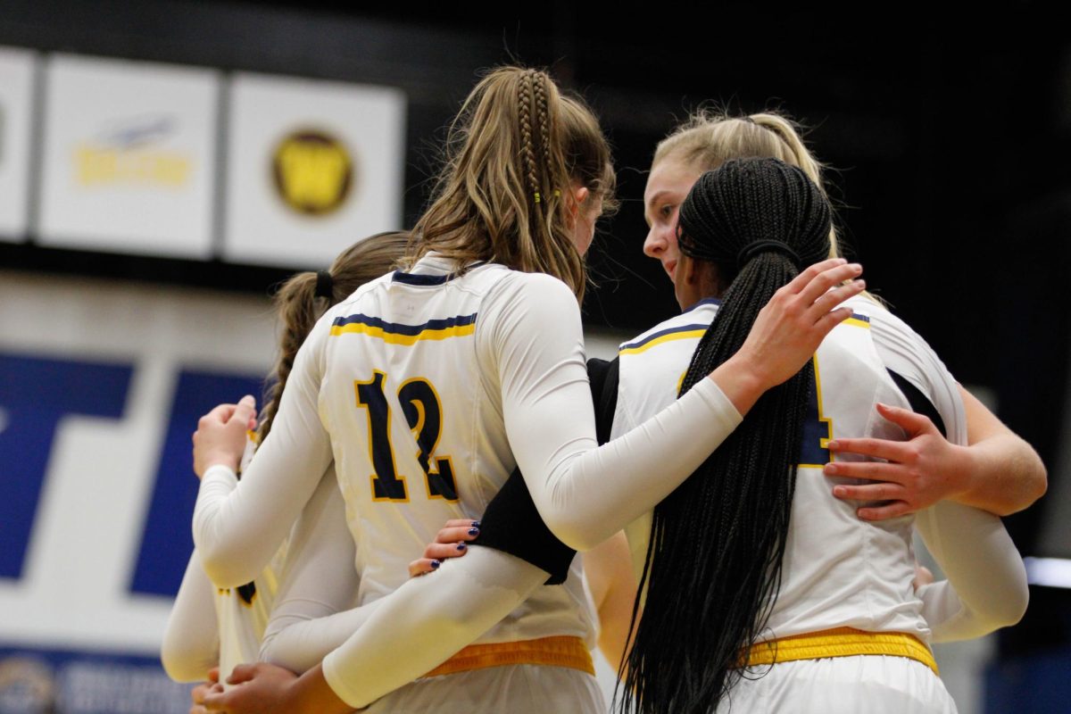 Kent State University Women's Basketball team huddles up for a talk during their match against the University of Akron on Feb. 1, 2025. 