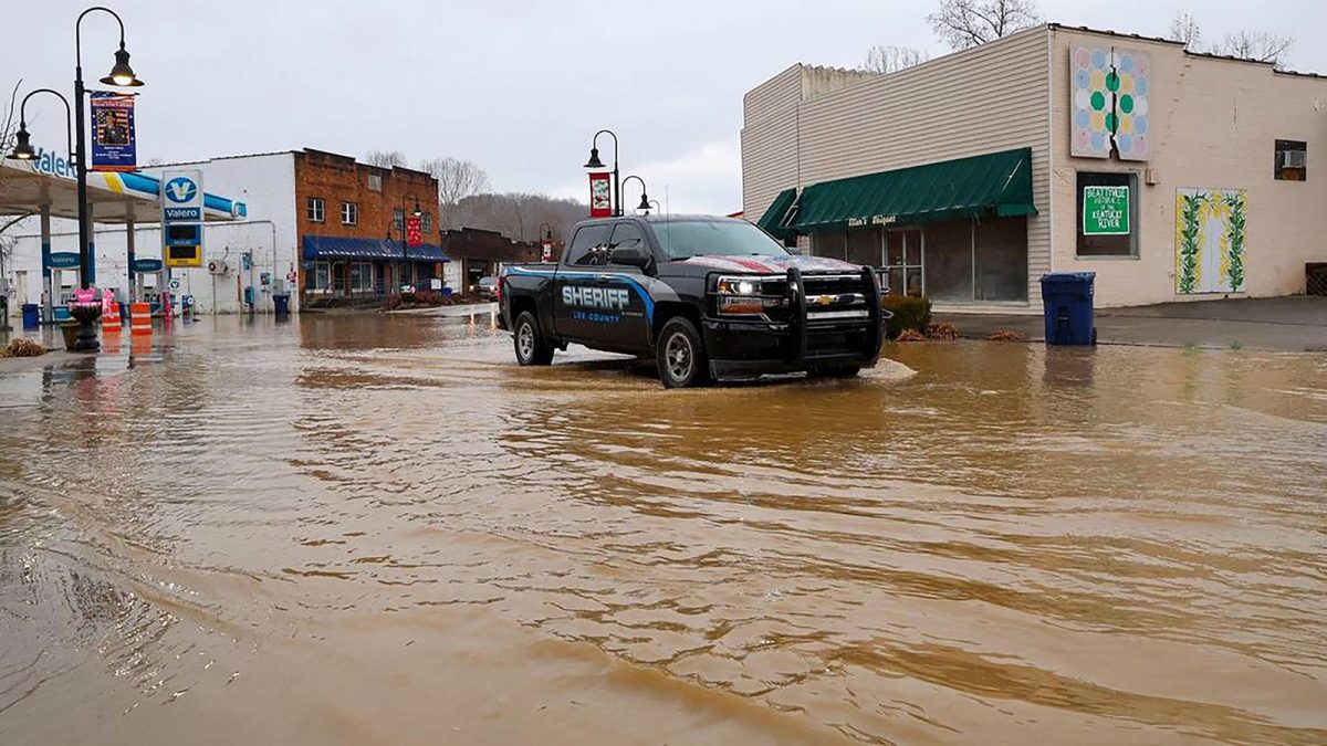 A Lee County sheriff's truck drives through floodwaters Sunday in downtown Beattyville, Kentucky.