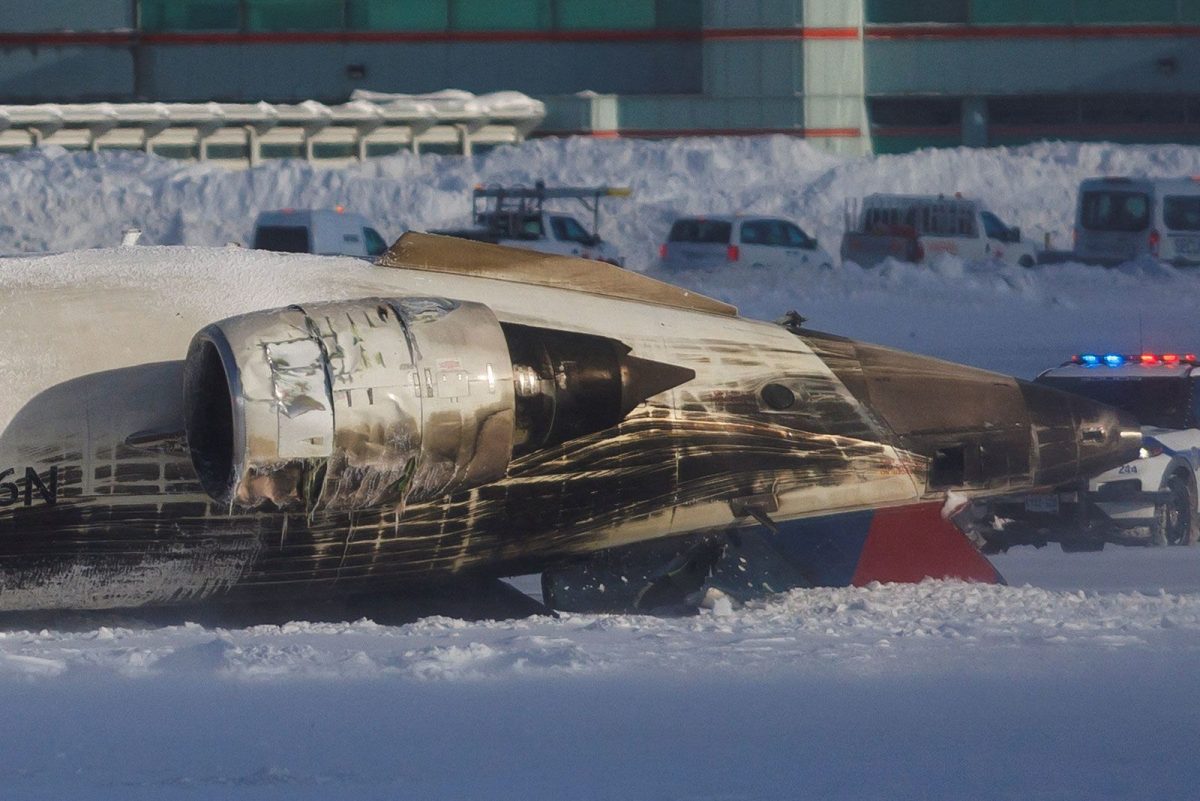 Emergency responders work after a plane crash at Toronto Pearson International Airport in Mississauga, Ontario, Monday.