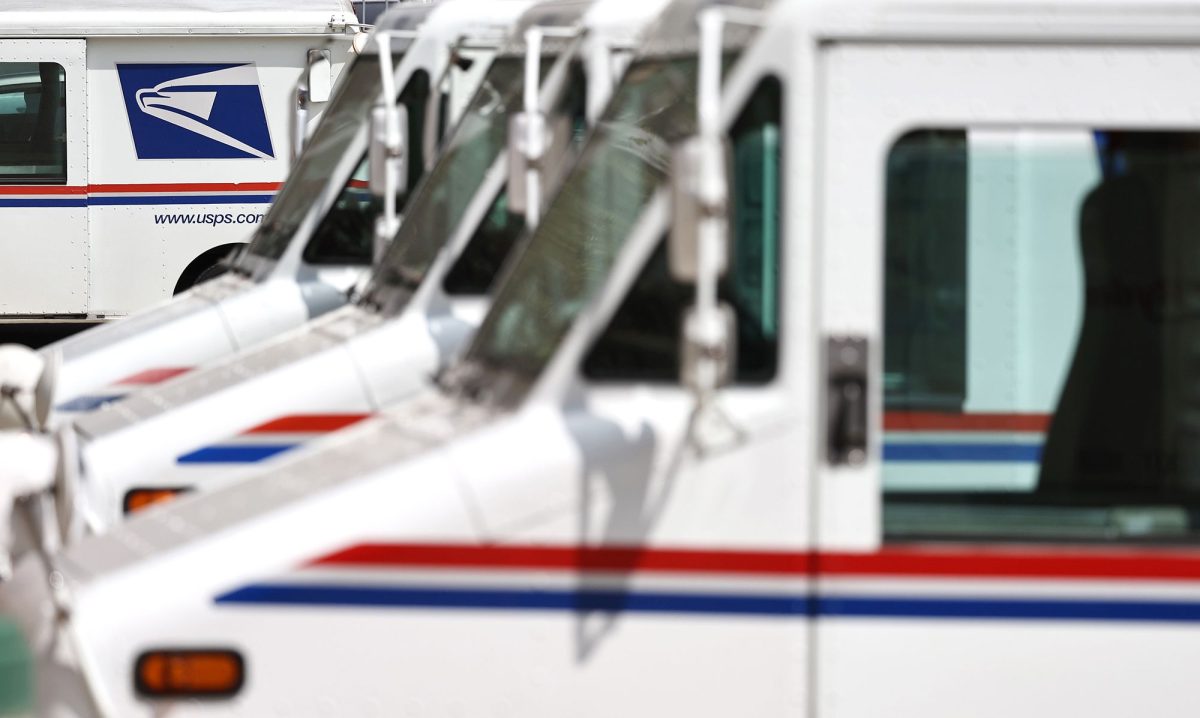 U.S. Postal Service trucks are parked at a post office in Glendale, California.