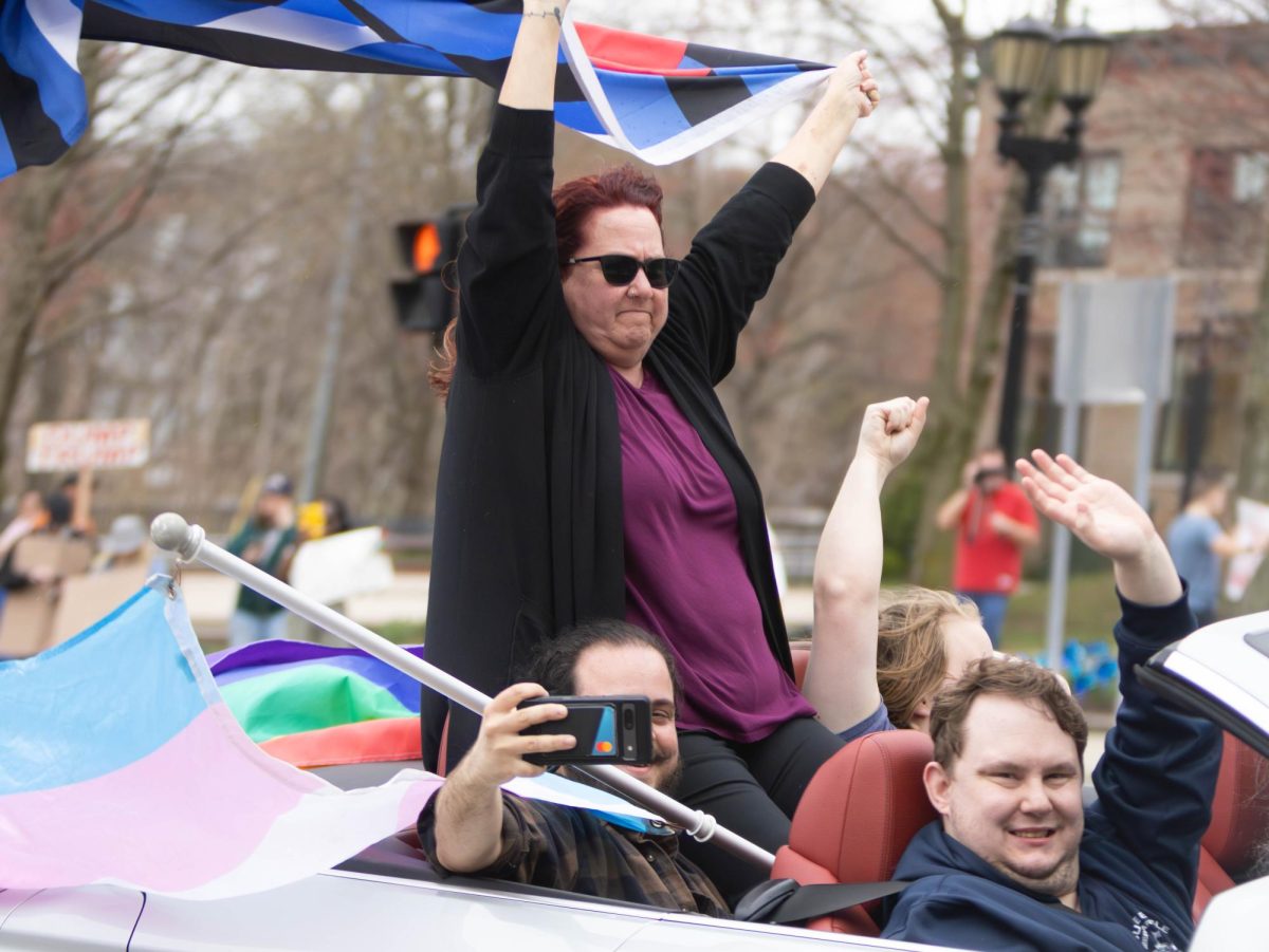A car of protesters drive down Main Street during the Hands Off protest, April 5, 2025.
