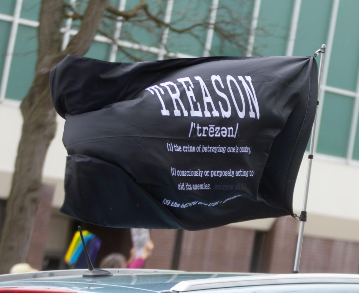 A car waves a flag protesting the Trump Administration during the Hands Off protest in Downtown Kent, April 5, 2025.