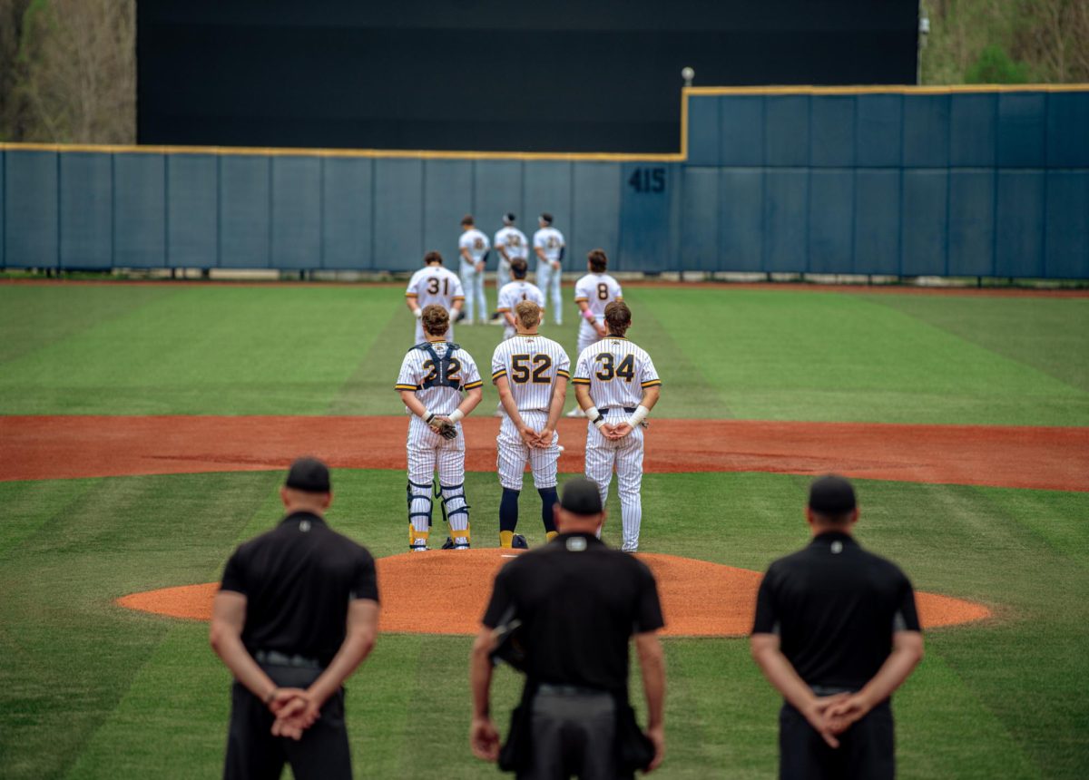 The Kent baseball team stands during the national anthem before their game against Akron on Friday, April 25, 2025.