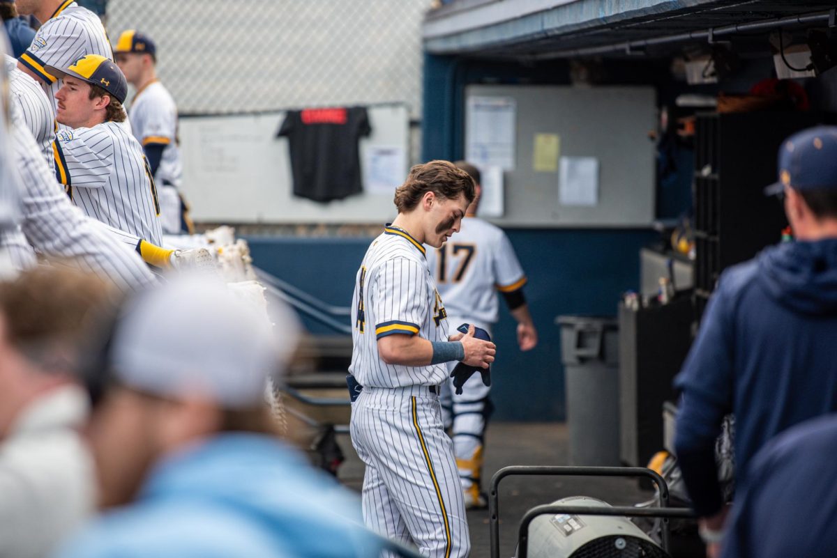 Kent sophomore Alejandro Covas stands in the dug out on Tuesday, March 4, 2025 