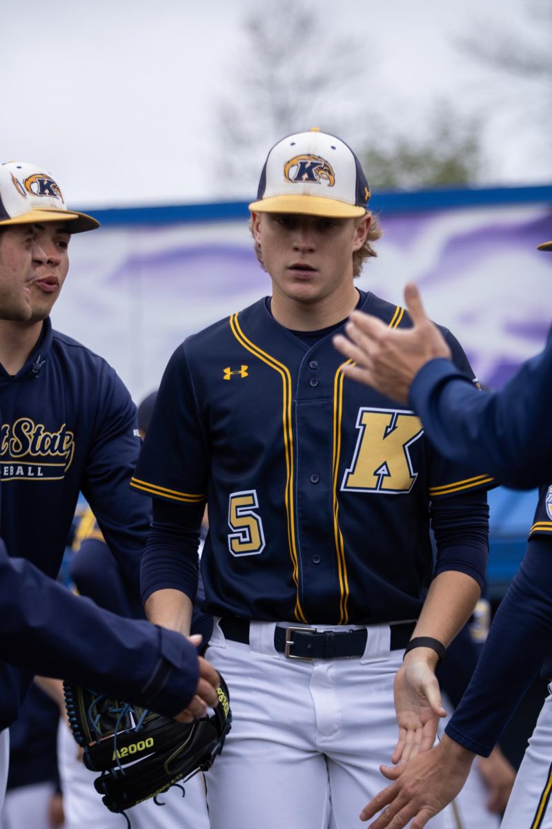 Kent sophomore Jake Bean walks out while his teammates give him high fives before their game against Akron on Saturday, April 26, 2025. 