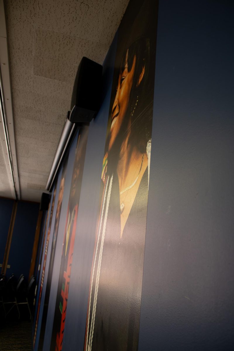 A mural of photographs on the wall in Kent's Multicultural center represents people of succeeding their goals. 