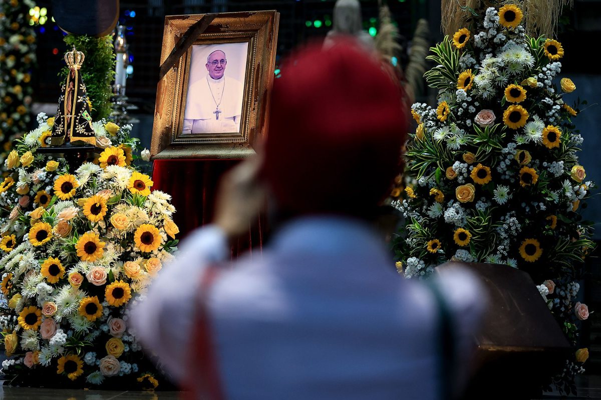 A mourner looks upon a portrait of the late Pope Francis at the Rio de Janeiro Metropolitan Cathedral, in Brazil, on April 21. The funeral for the 88-year-old pontiff will take place at the Vatican, on Saturday.