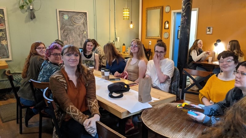 Queer and trans individuals attending "Brewed this Way" pose for a picture between talking about their experiences over cups of coffee at Scribbles Coffee Company on Saturday, April 26.