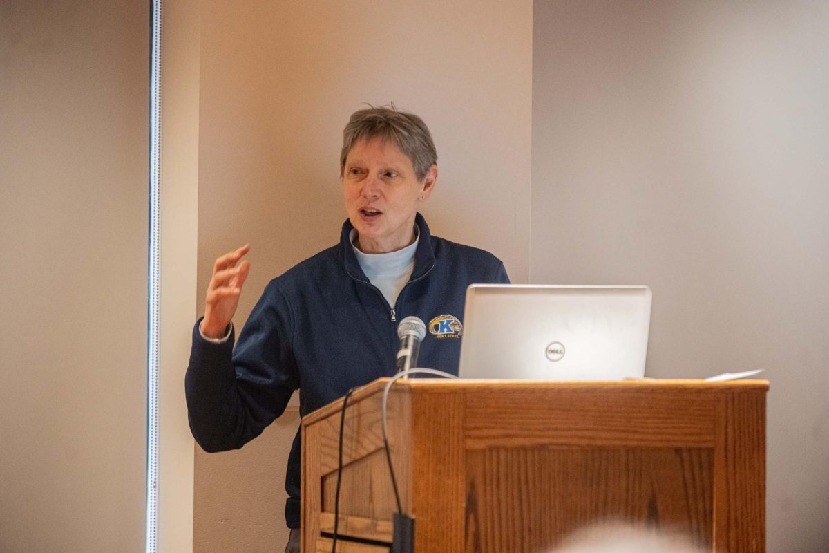 Kathy Wilson, professor in the Department of Economics and co-chair of the Engagement and Well-Being Survey Committee, shares the findings of the survey with attendees on April 9, 2025.
