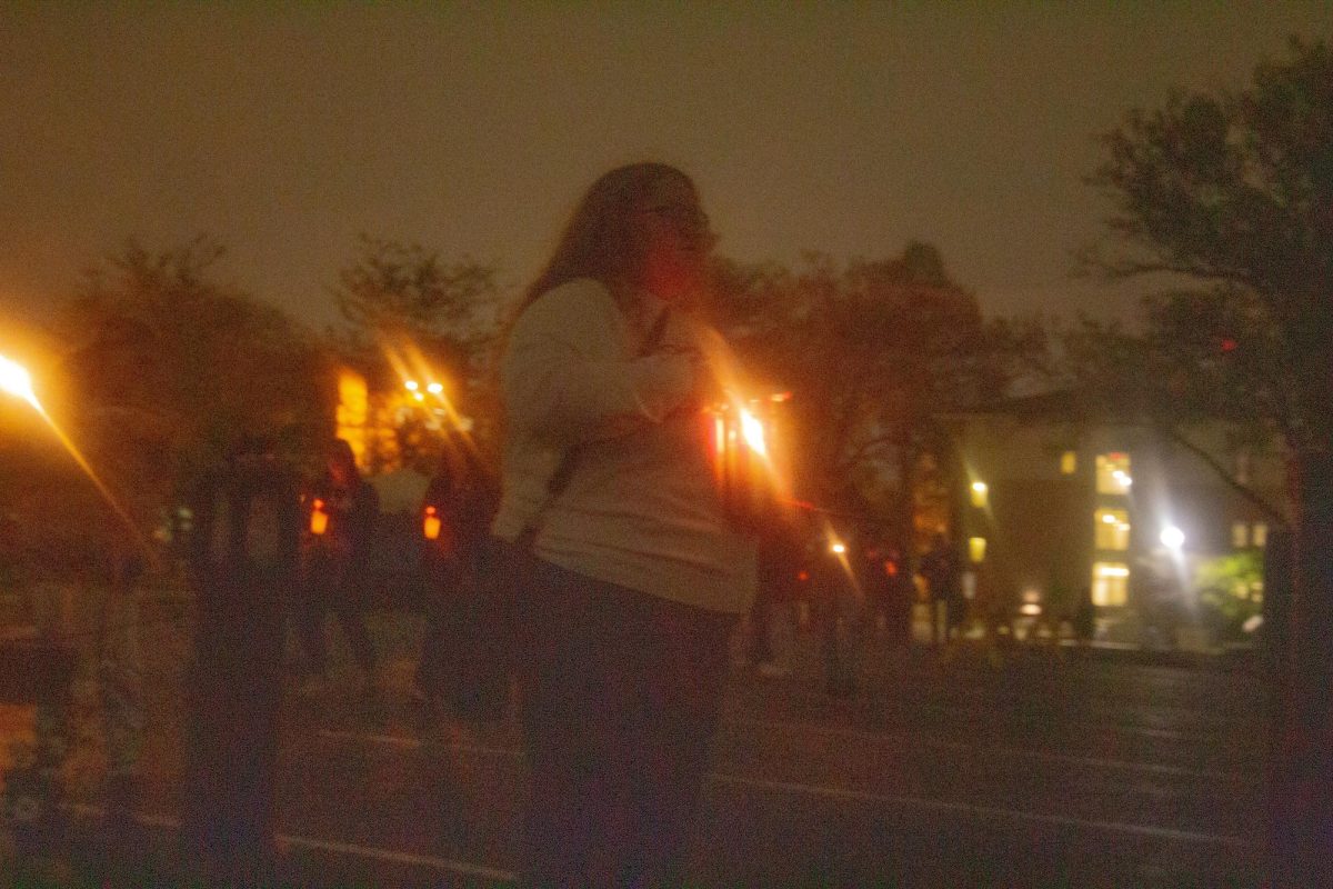 KSU Student stands in place at grave of Sandra Scheuer to pay homage and honor her life being taken fifty five years ago, on May 3, 2025.