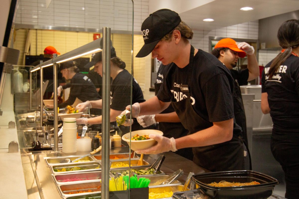 Bibi Bop Associate prepares customer's food at station on May 22, 2025.