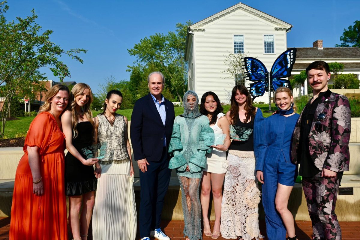 Jackie Hughes (far left), Daniel Fladung (far right) and Kent State President Todd Diacon (center) with the winning looks and their designers from the "Dalí Beyond Time" exhibit. 